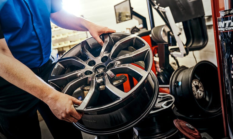 Technician changing out wheel